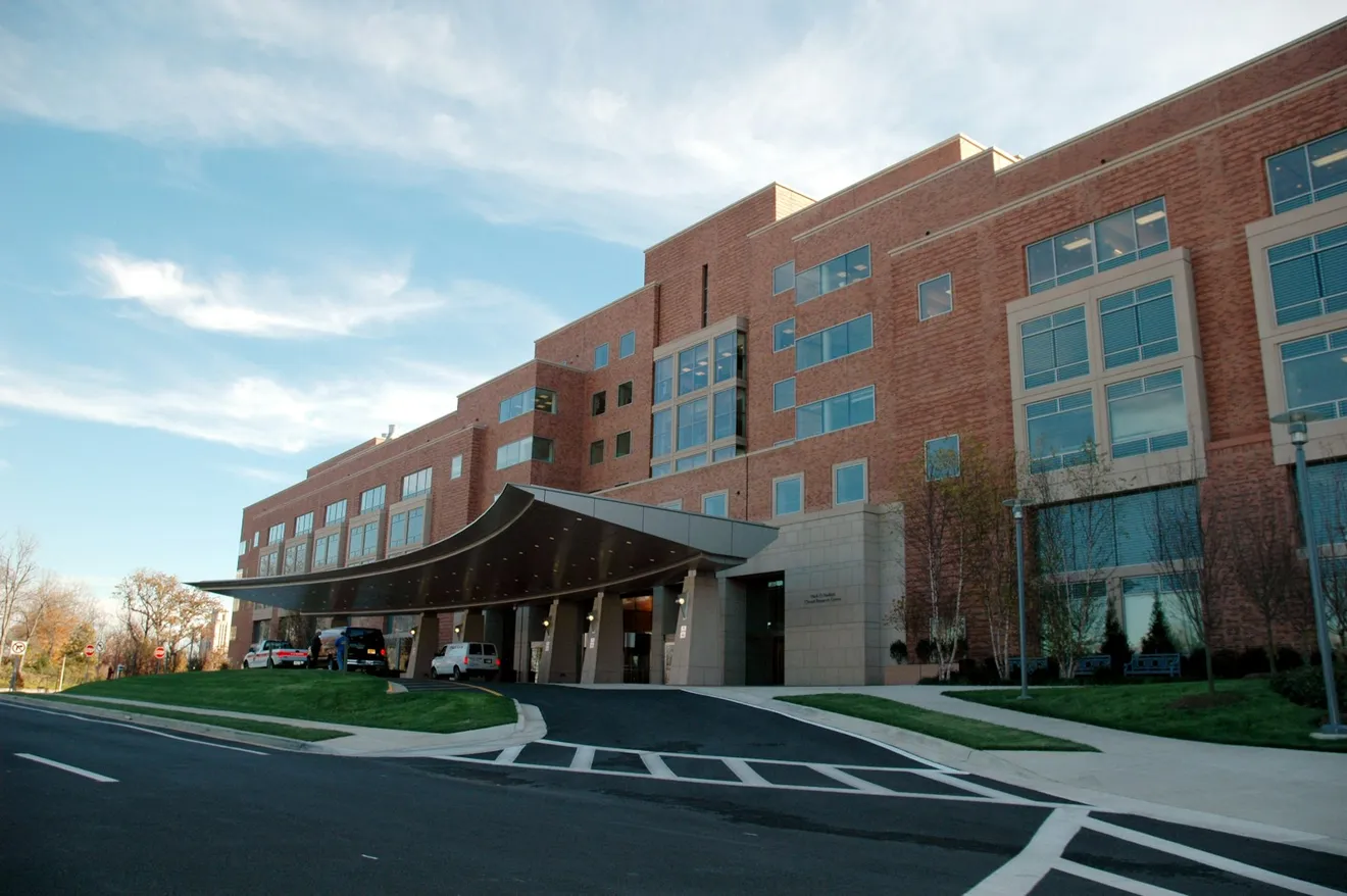 A modern medical building entrance with a covered, step-free walkway (illustrative stock photography)